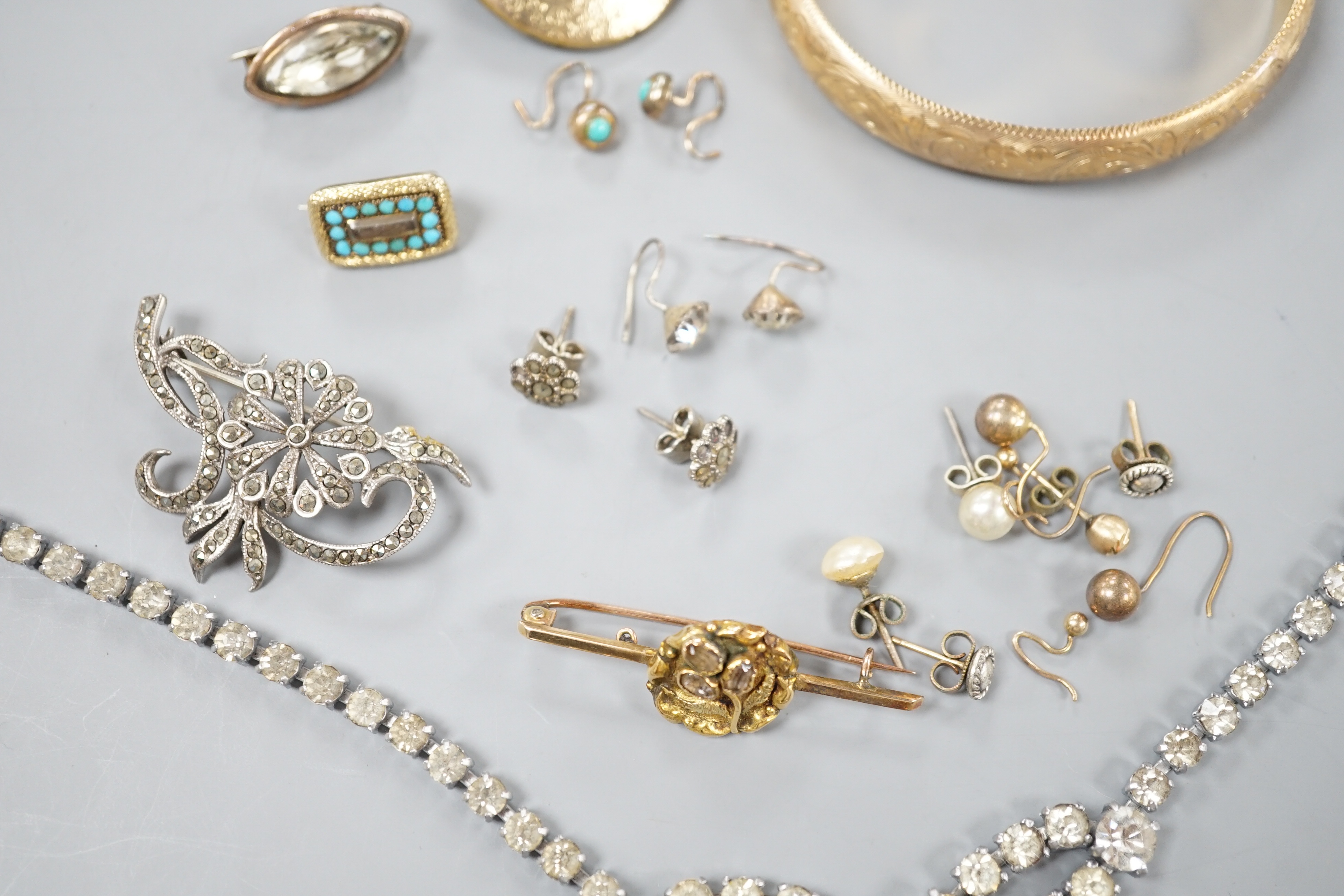 A 9ct gold hinged bangle, 17.4 grams, an engraved yellow metal locket, a 9ct and gem set bar brooch, gross 3.3 grams, a Victorian yellow metal and turquoise set small mourning brooch, one other brooch, assorted earrings